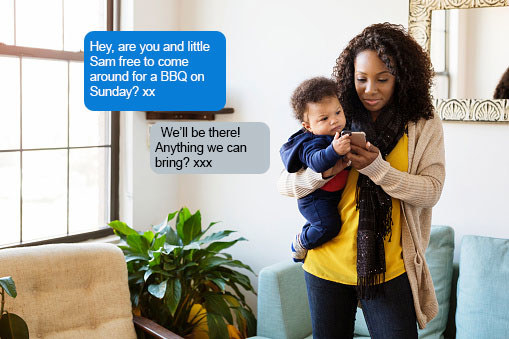 A woman holds her baby while looking at her phone. A received text reads, &quot;Hey, are you and little Sam free to come around for a BBQ on Sunday? xx&quot; while a sent text reads, &quot;We&#x27;ll be there! Anything we can bring? xxx&quot;