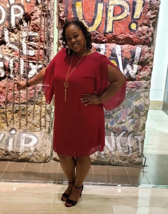 Reviewer wearing the cold shoulder dress in red