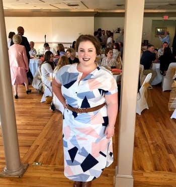 Reviewer wearing the geometrically patterned dress in blue, pink, and white