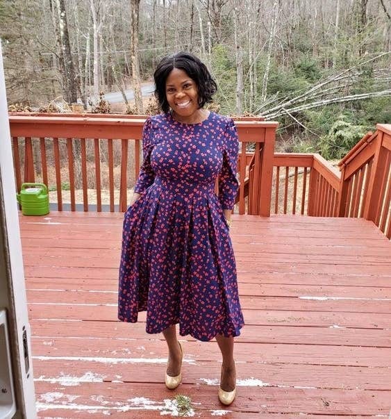 Reviewer wearing the midi three quarter sleeve dress in blue and purple floral print