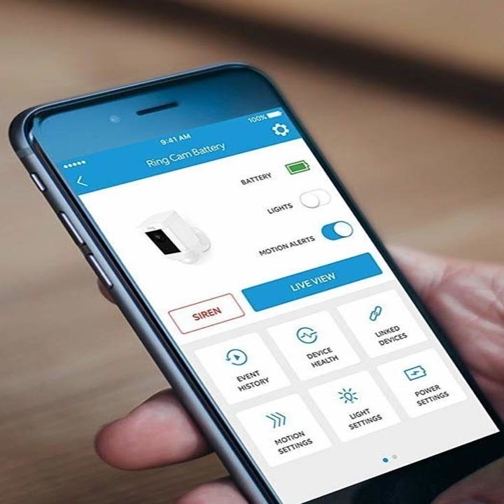 A person setting up the camera with their phone