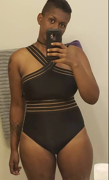 Reviewer in black one piece with straps that cross at the chest  