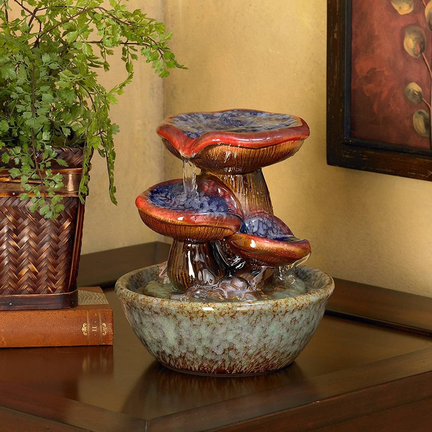 a fountain with water pouring down three mushrooms