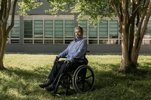Francis Brauner sits in his wheelchair in front of an institutional building