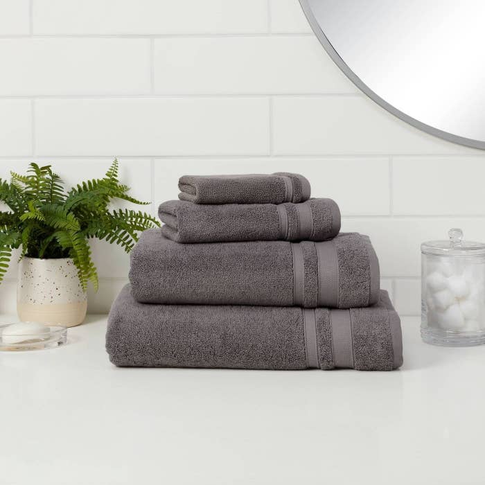 A set of grey bath towels in a home