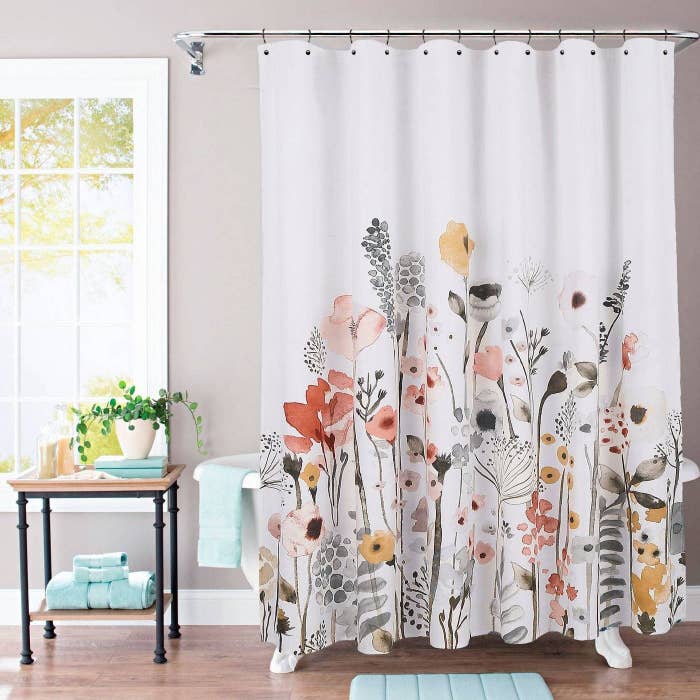 A multi-colored flower shower curtain in a home