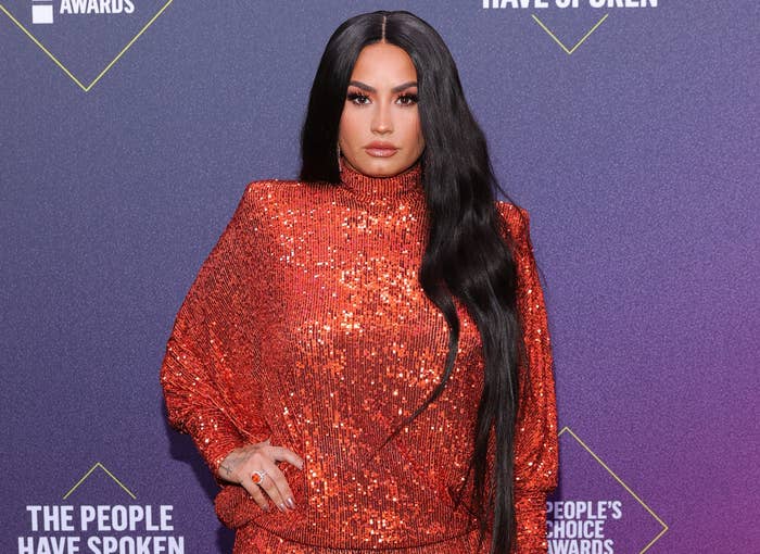 Demi wears a shimmering-red sequined jumpsuit