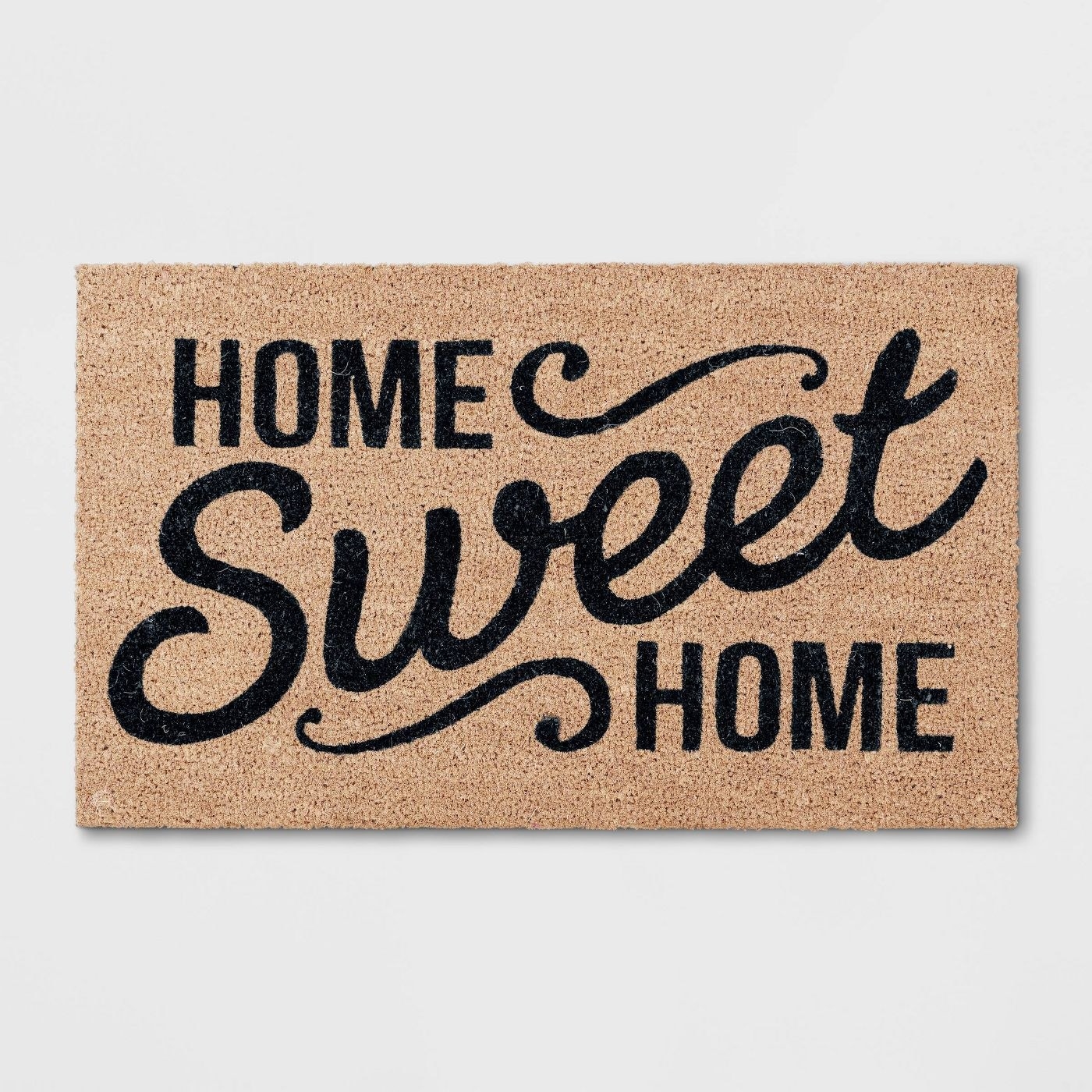  &quot;Home sweet home&quot; in black font on a brown mat 