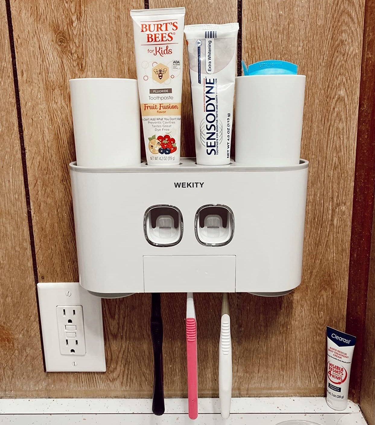 the white wall mounted toothbrush holder