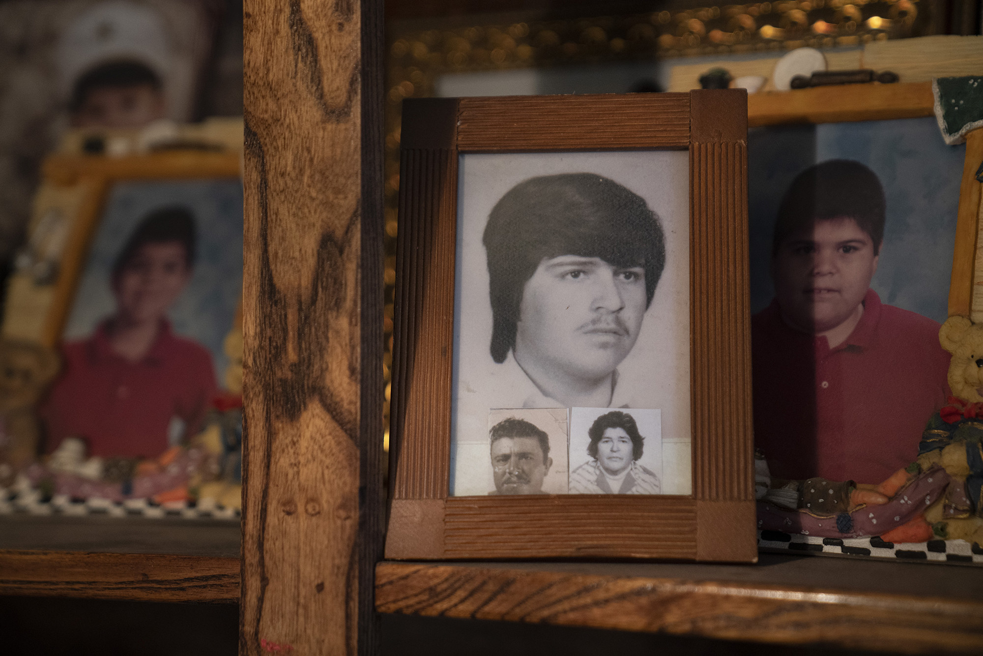 A collection of black-and-white and color family photos on a shelf