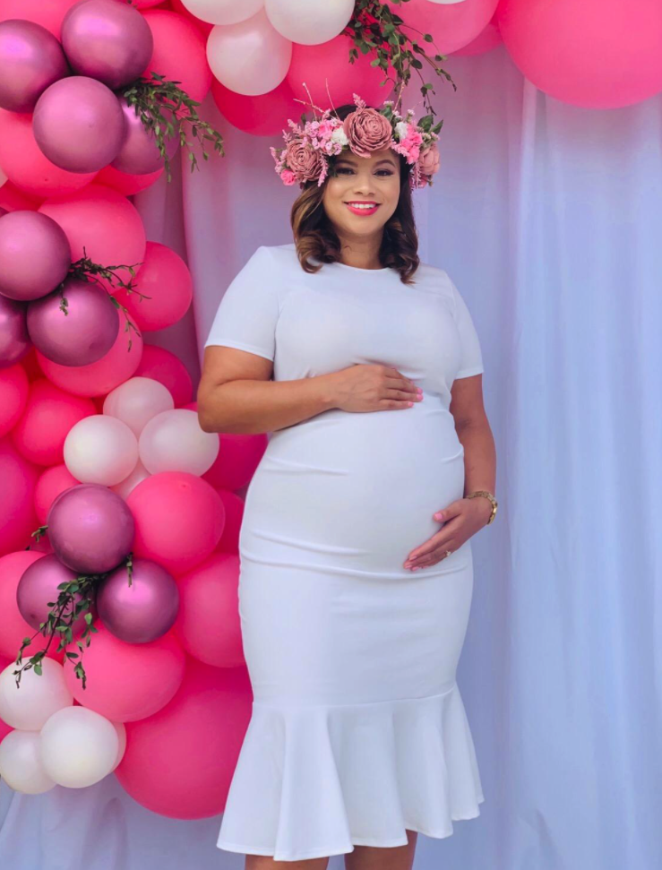 pregnant reviewer wearing the white version at baby shower