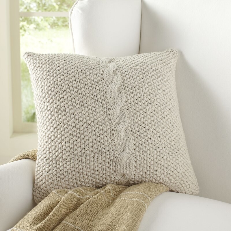 Classic throw pillow on cream couch