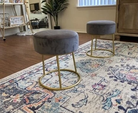 a reviewer&#x27;s gray velvet stool on an area rug