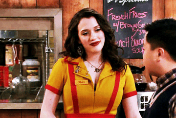 Kat Dennings in Two Broke Girls looking strongly at a customer 