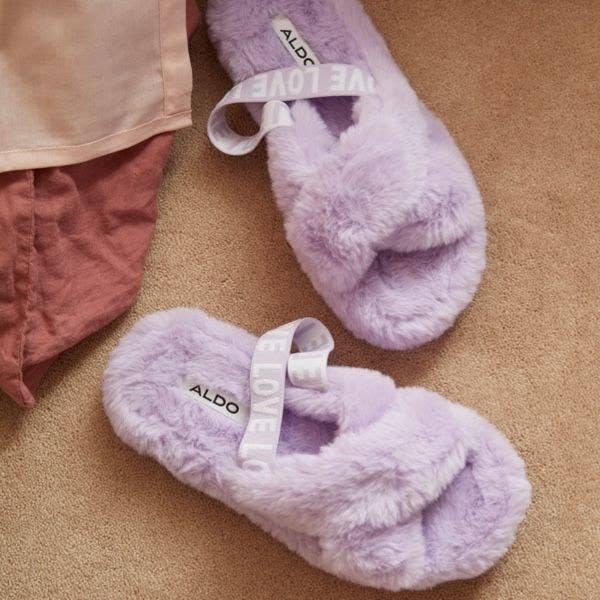 A pair of furry slippers on a carpet