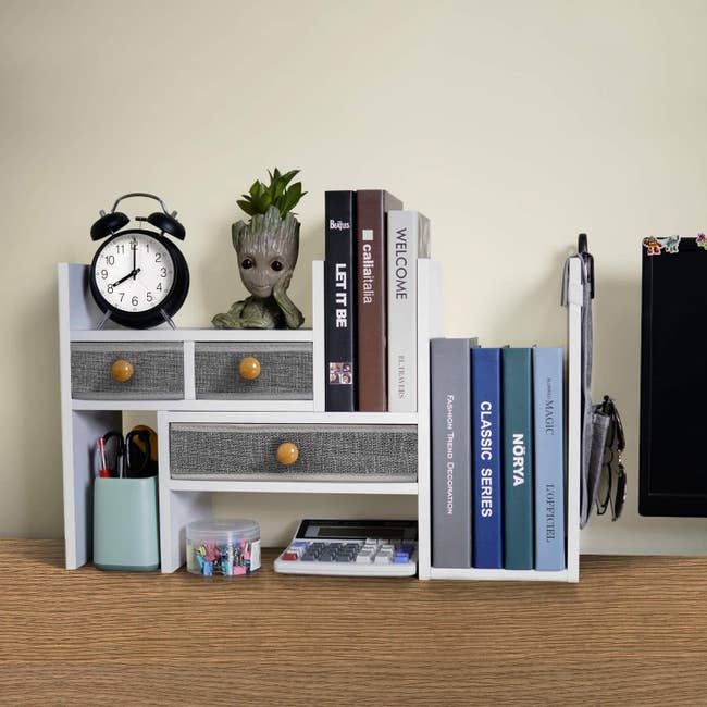 the white desktop organizer with grey linen pull-out drawers