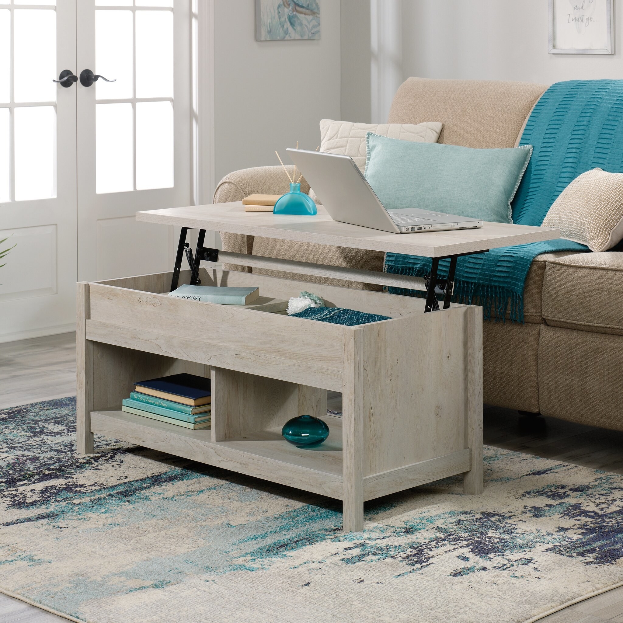 the chalked chestnut coffee table with the top lifted and elevated to show the storage capacity