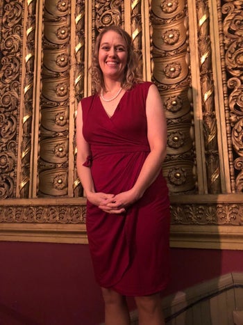 reviewer wearing the dress in maroon