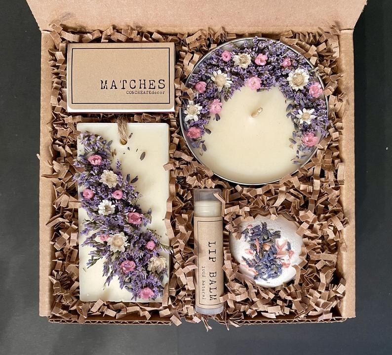 the lavender vanilla -cented gift box with a candle, bath bomb, lip bam, soap and matches