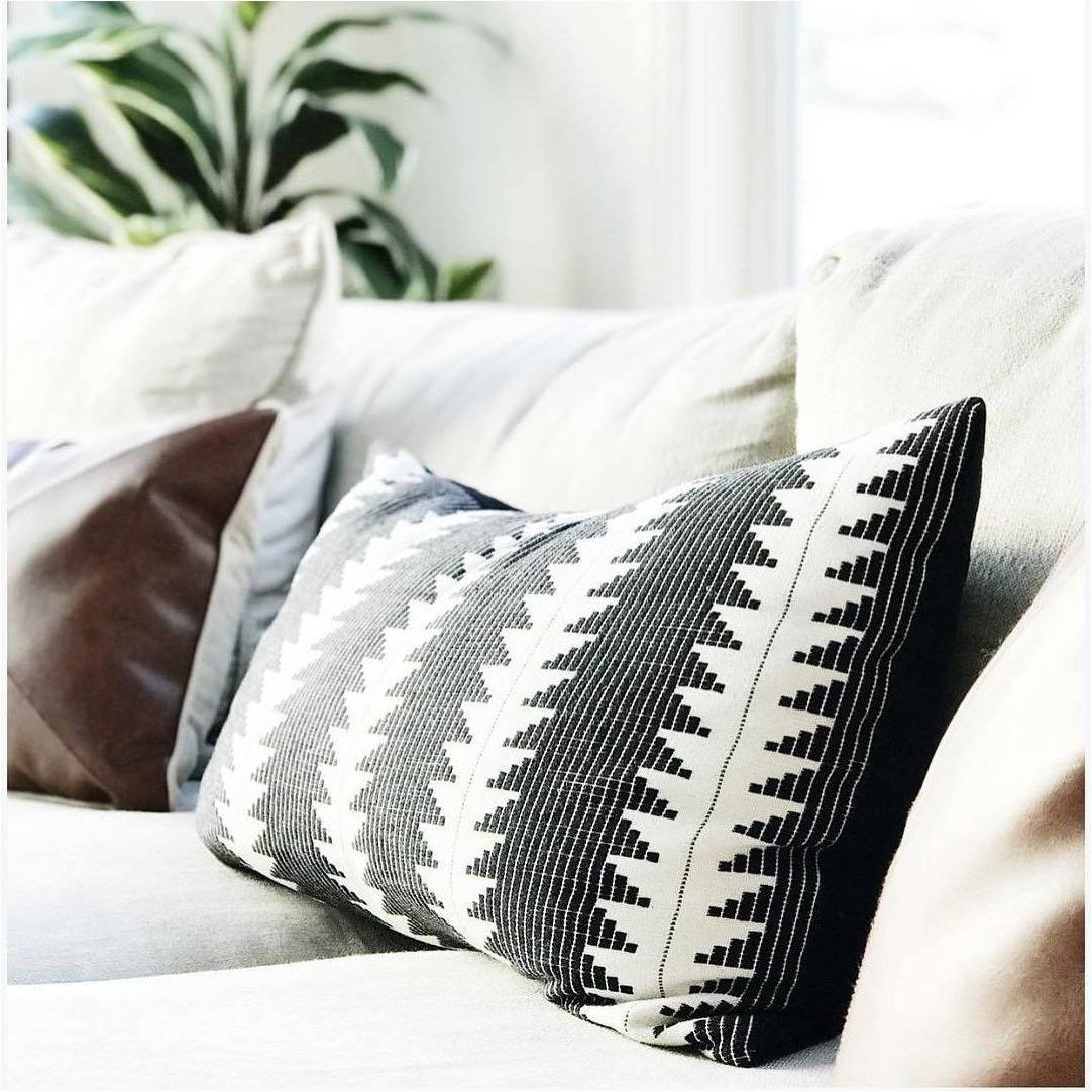 black and white geometric patterned lumbar pillow on a couch