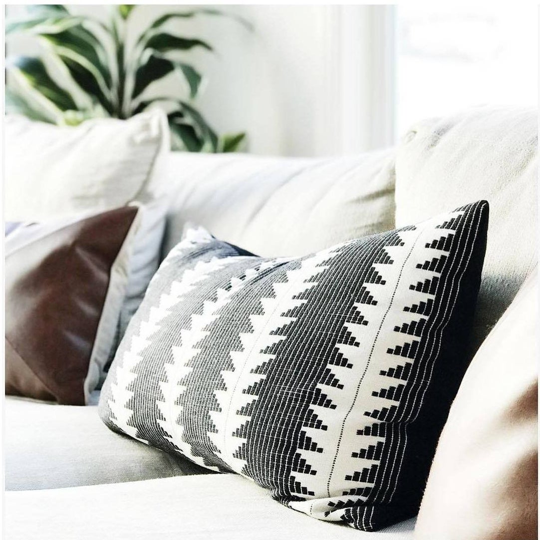 black and white geometric patterned lumbar pillow on a couch