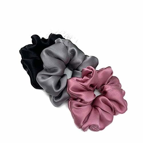 Pink, grey, and black satin scrunchies.