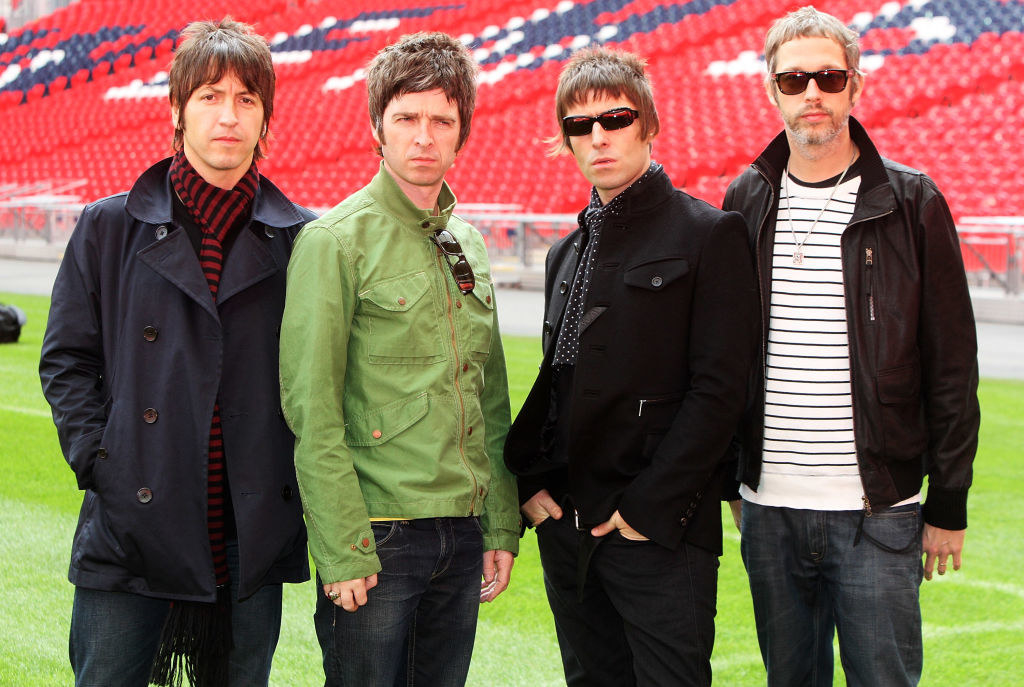 Gem Archer, Noel Gallagher, Liam Gallagher, and Chris Sharrock at Oasis press conference in October 2008