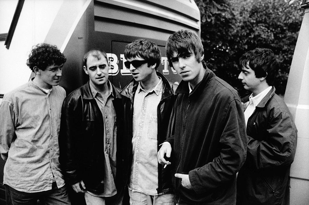 Tony McCarroll, Paul &quot;Bonehead&quot; Arthurs, Noel Gallagher, Liam Gallagher, Paul &quot;Guigsy&quot; McGuigan posing for a group shot in the early &#x27;90s