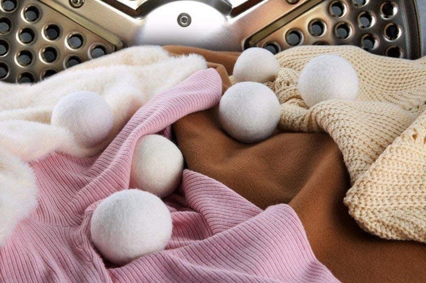 The woold dryer balls in a dryer with fresh clothes 