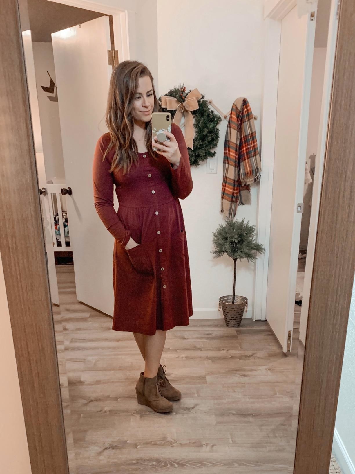 reviewer takes picture in the midi dress with button down the front 