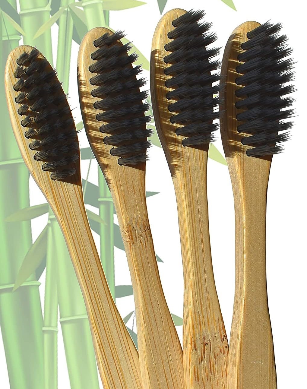 Four bamboo toothbrushes against a bamboo backdrop 