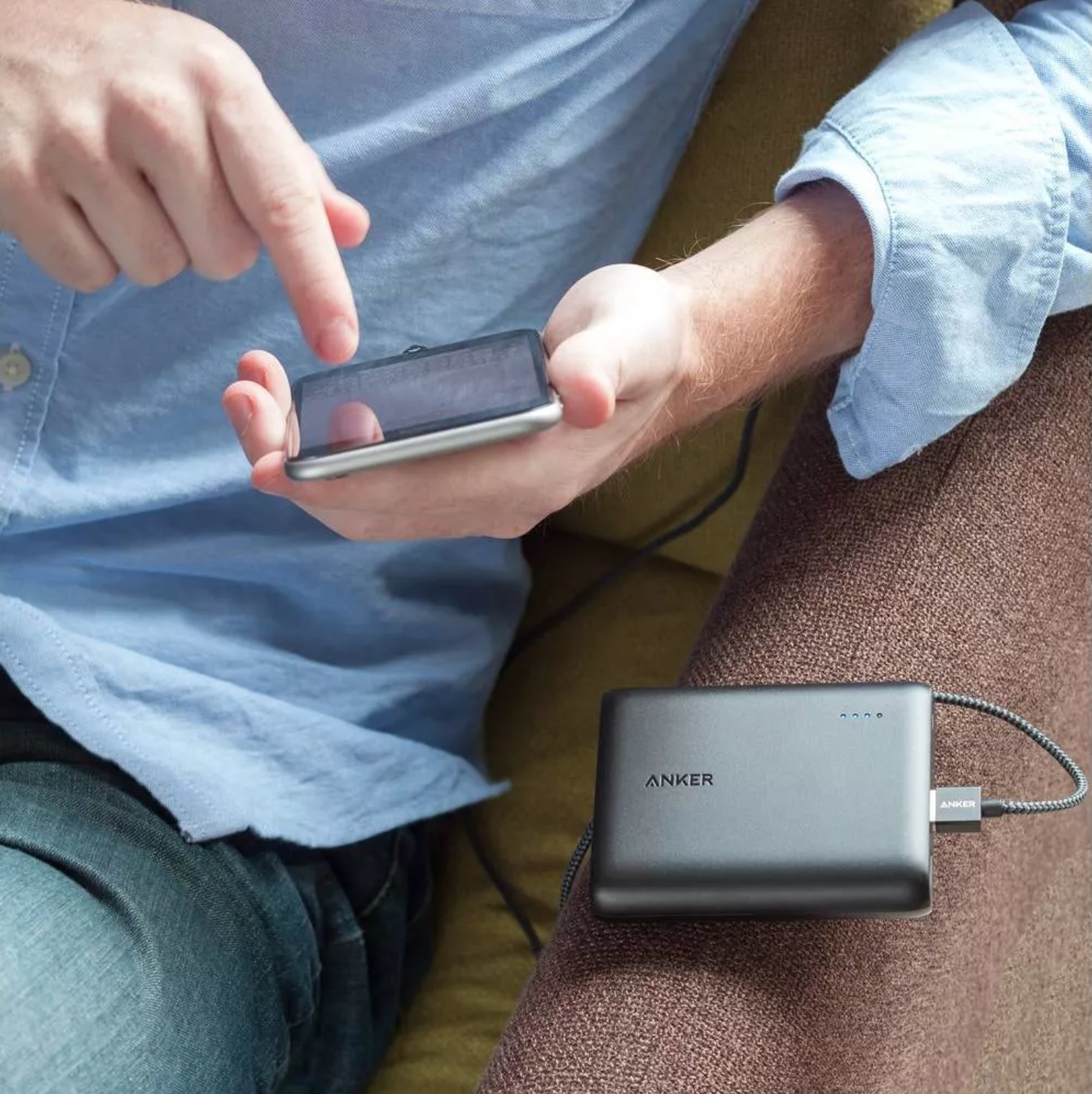 person using the power bank attached to their phone
