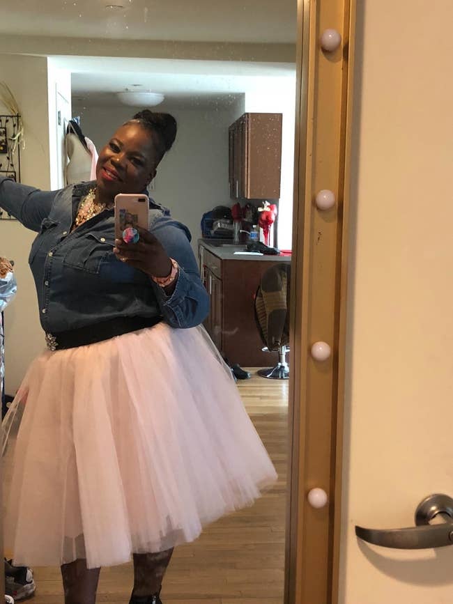 reviewer takes selfies wearing pink tulle skirt 