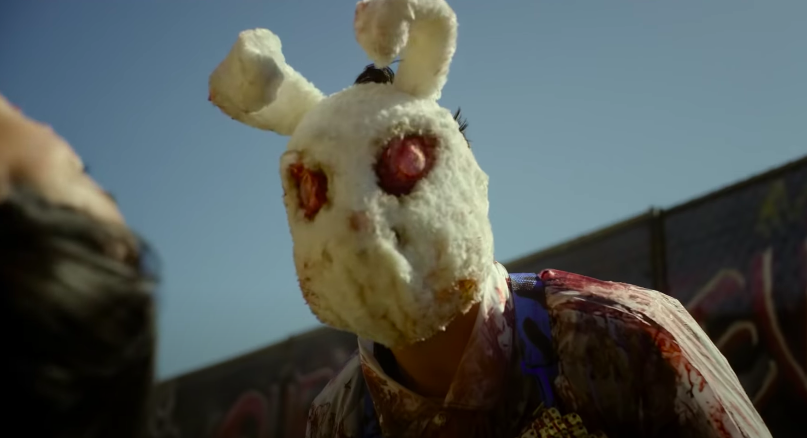 A grungy-looking rabbit mask with red eyes
