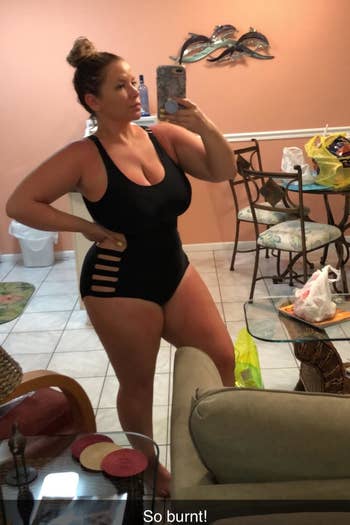 Reviewer wearing the black swimsuit with side cutouts
