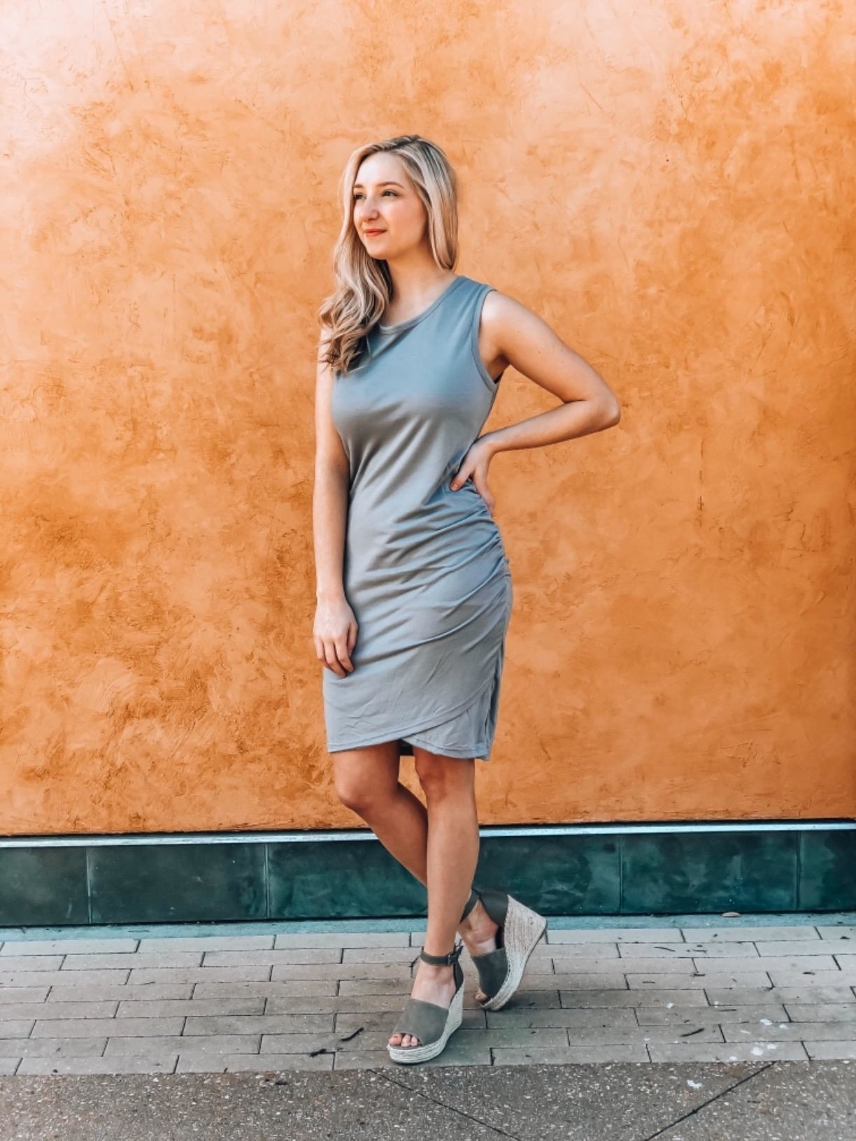 Reviewer wearing grey dress, stops above the knee