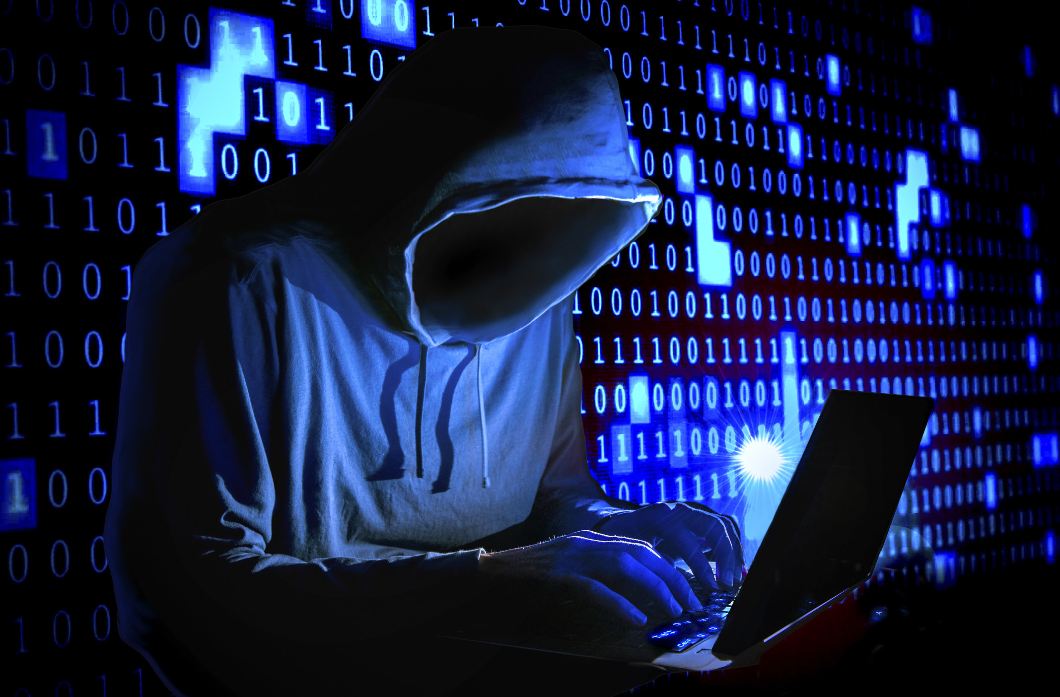 a guy in a hoodie surfing the dark web