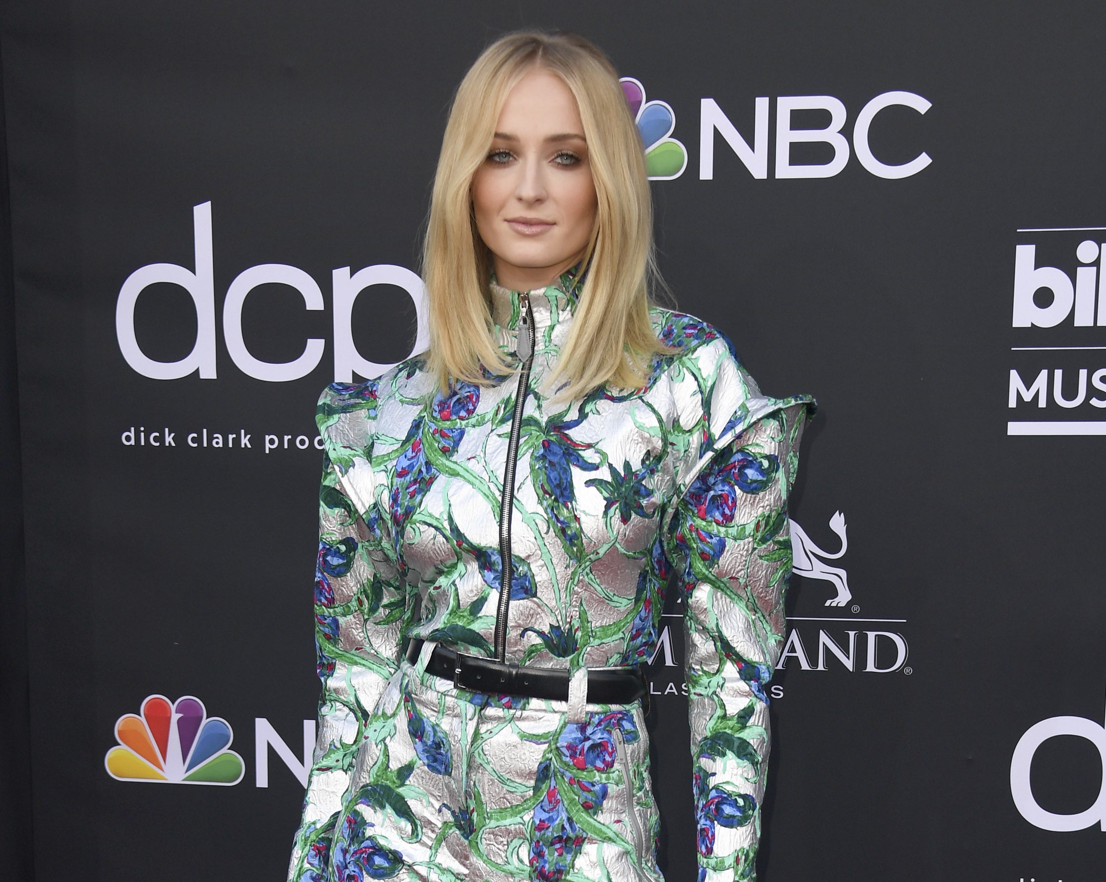 Sophie wears a silver jumpsuit to an awards show