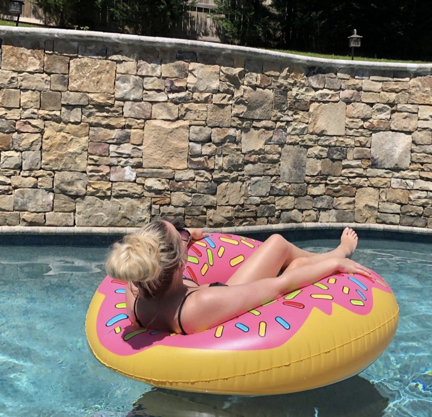 A person on a donut-shaped pool float