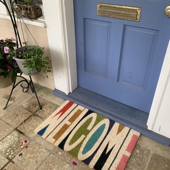 the rainbow-colored welcome mat in front of a reviewer&#x27;s door