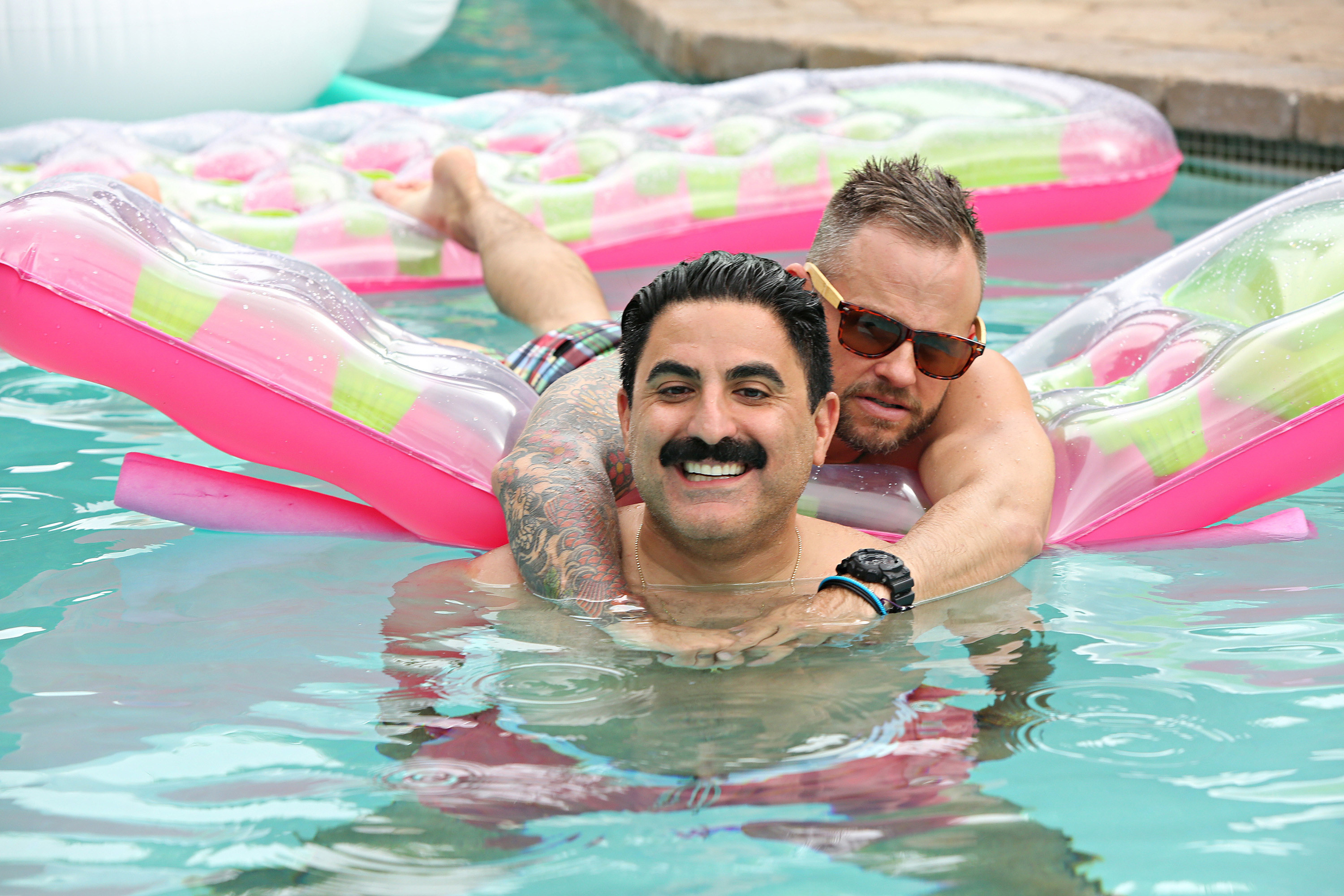 Reza Farahan and Adam Neely in a swimming pool