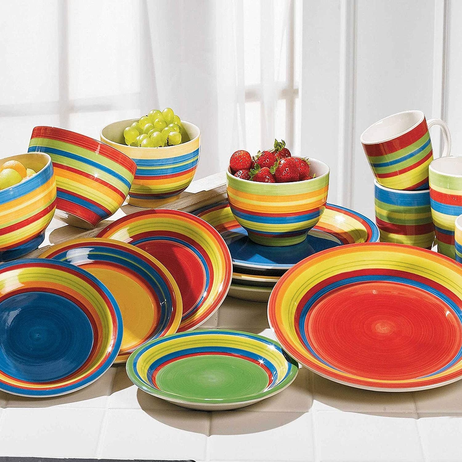 a cornucopia of brylane home santa fe hand painted plates and bowls on a countertop
