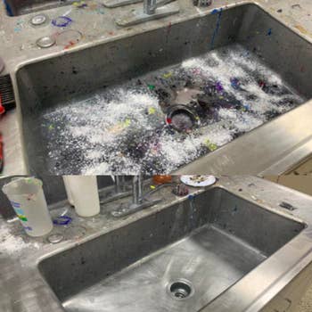 Paint-covered sink with the base cleaned using the product 