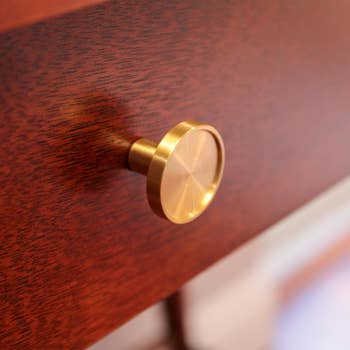 brass knob on a dark wood