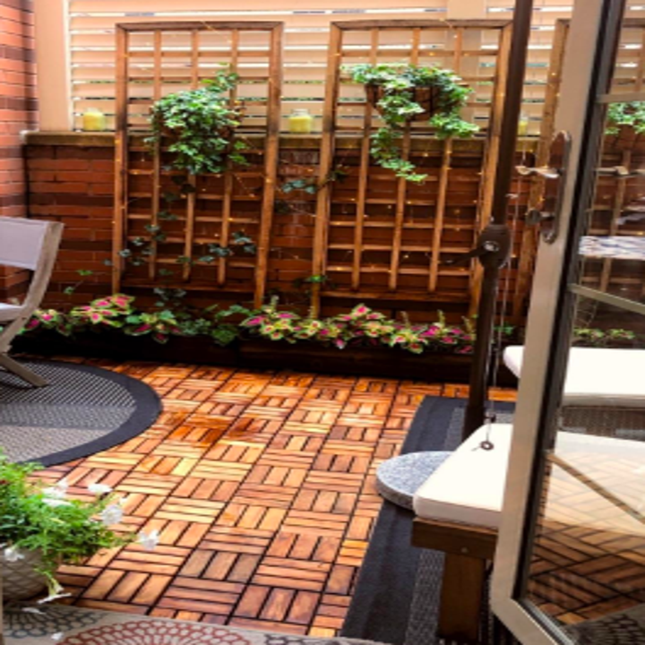 Backyard patio covered with the tiles 