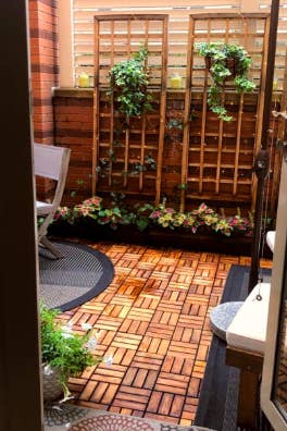 reviewer's backyard patio covered with the tiles 