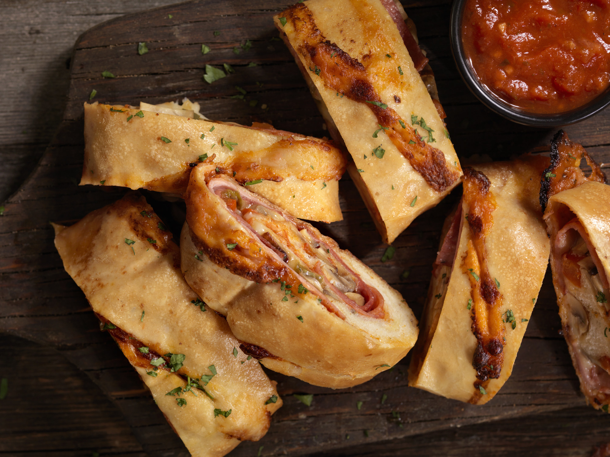 Sliced pepperoni rolls with marinara dipping sauce