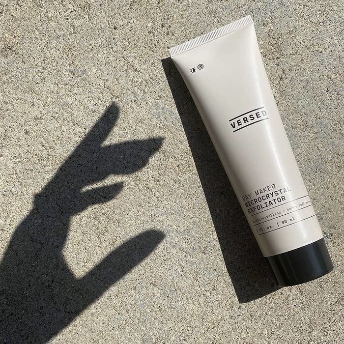 shadow of a hand reaching for Versed exfoliator