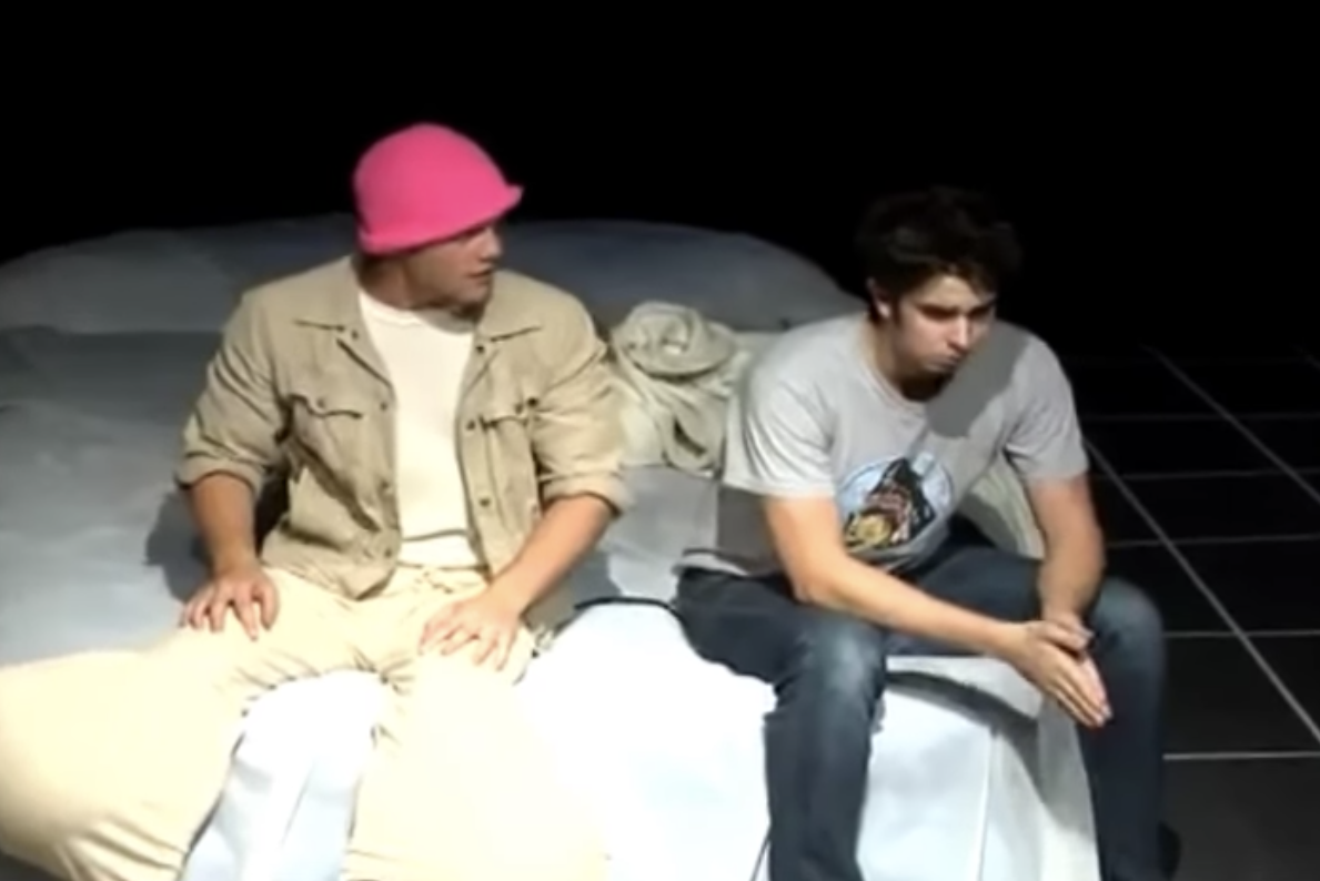boy on his bed talking to a man with pants that made his legs look like balls