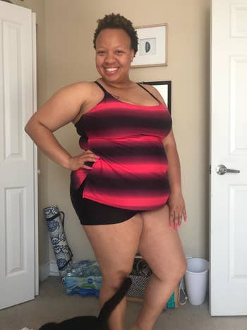 Reviewer wearing the black and pink striped tankini with black boyshort bottoms